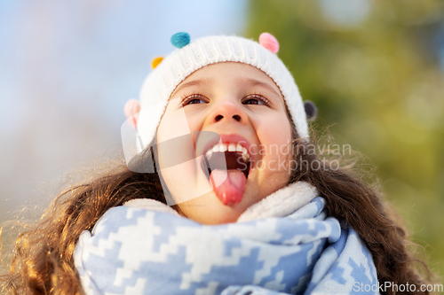 Image of happy little girl having fun at winter park