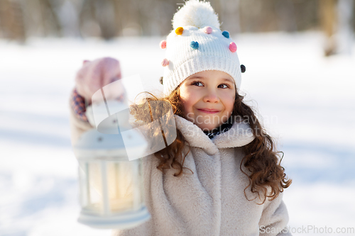 Image of happy little girl with christmas lantern in winter