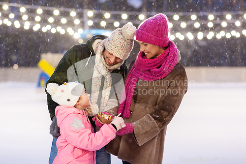 Image of happy family eating pancakes on skating rink