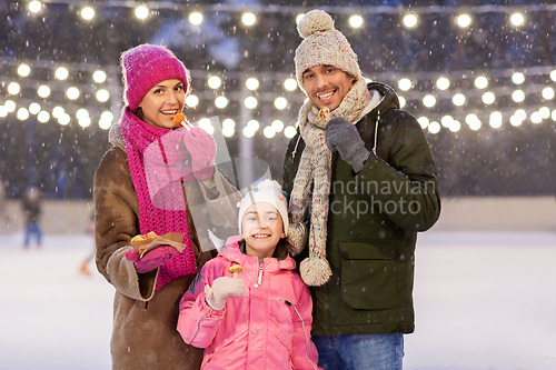 Image of happy family eating pancakes on skating rink