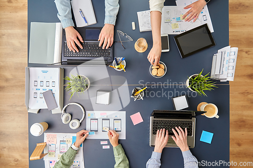 Image of business team with gadgets working at office table