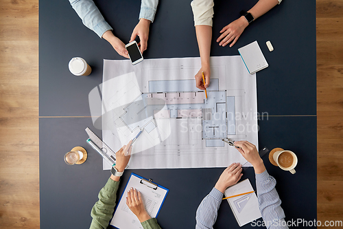 Image of business team with blueprint working at office