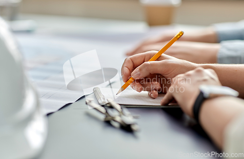 Image of architect with notebook working at office
