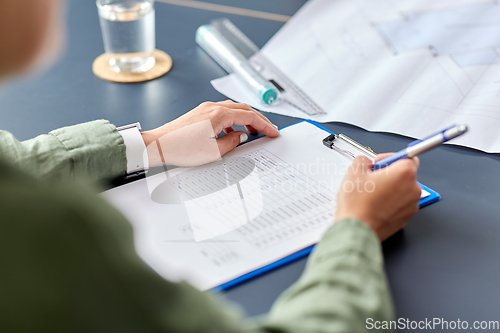 Image of architect with clipboard working at office