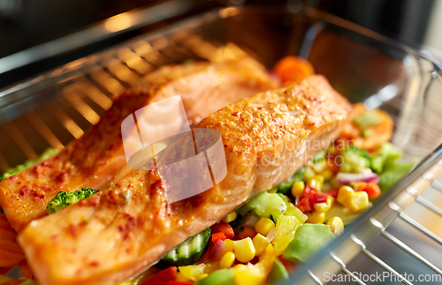 Image of food cooking in baking dish in oven at home