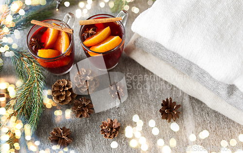 Image of mulled wine with orange and spices, cones and fir