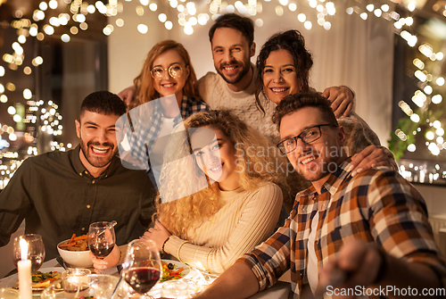 Image of friends taking selfie at christmas dinner party