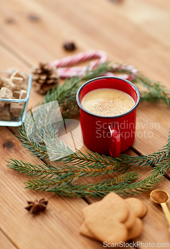 Image of cup of eggnog, fir branches, gingerbread and sugar