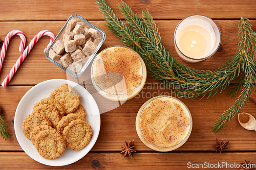 Image of glasses of eggnog, oatmeal cookies and fir branch