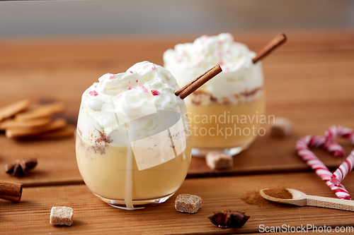 Image of glasses of eggnog with whipped cream and cinnamon