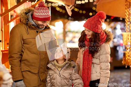 Image of happy family at christmas market in city