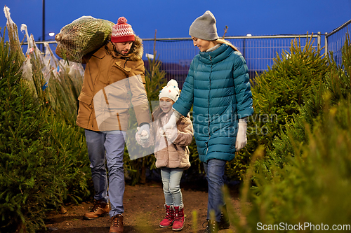 Image of happy family buying christmas tree at market