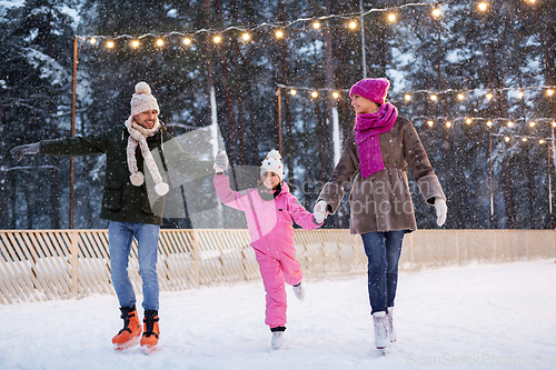 Image of happy family at outdoor skating rink in winter