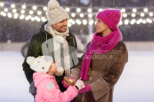 Image of happy family eating pancakes on skating rink