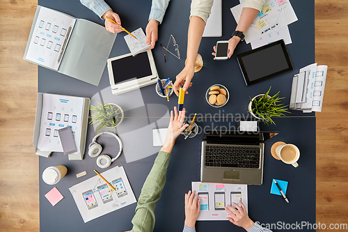 Image of business team with gadgets working at office table