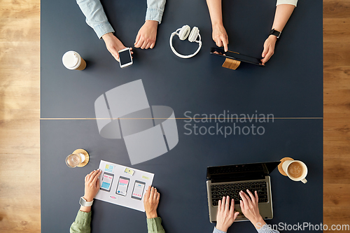 Image of business team with gadgets working at office table