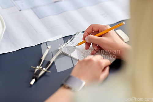 Image of architect with notebook working at office