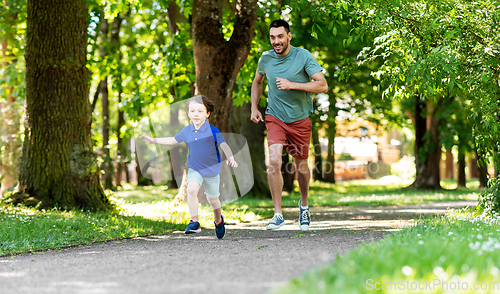 Image of happy father and son compete in running at park