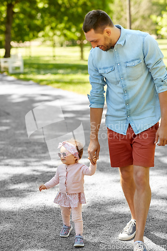 Image of happy father with baby daughter at summer park