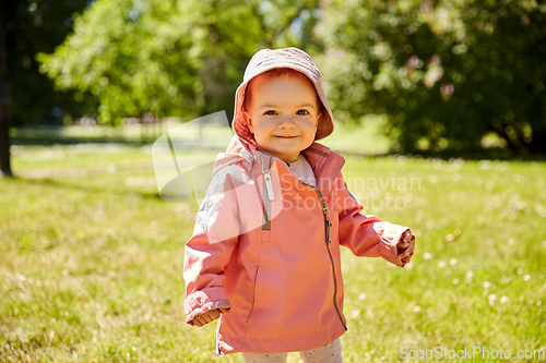 Image of happy little baby girl at park in summer