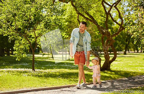 Image of happy father with baby daughter at summer park