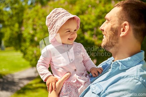 Image of happy father with baby daughter at summer park