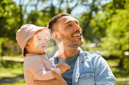 Image of happy father with baby daughter at summer park