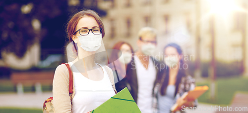 Image of teenage student girl in mask with school friends