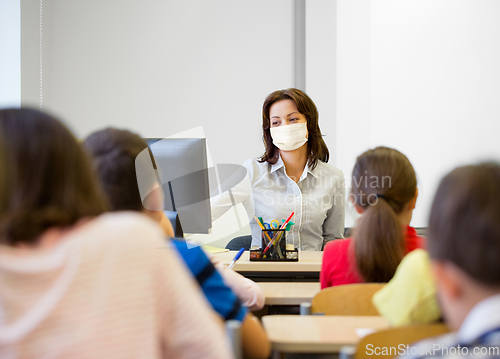 Image of teacher wearing face protective mask at school