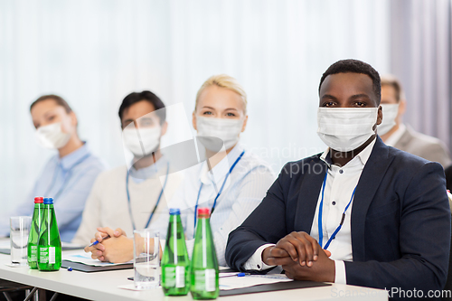 Image of business people in masks at worldwide conference