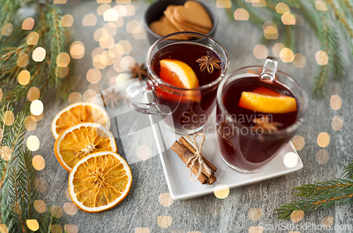 Image of mulled wine, orange slices, gingerbread and spices