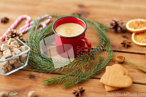Image of cup of eggnog, fir branches, gingerbread and sugar
