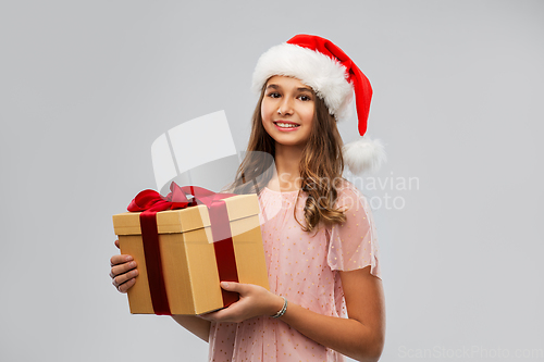 Image of teenage girl in santa hat with christmas gift