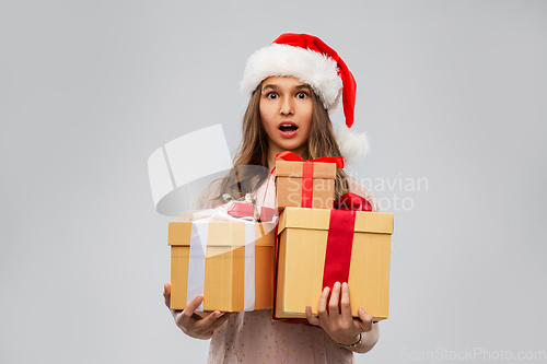 Image of teenage girl in santa hat with christmas gift