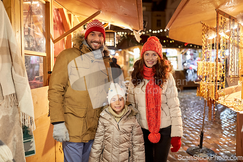 Image of happy family at christmas market in city