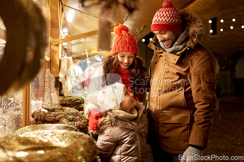 Image of happy family at christmas market in city