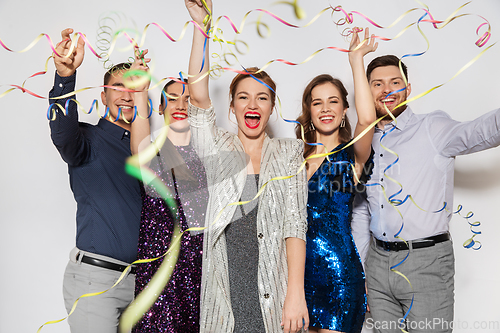 Image of friends throwing party streamers and having fun