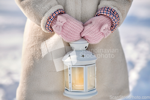 Image of close up of girl with christmas lantern in winter