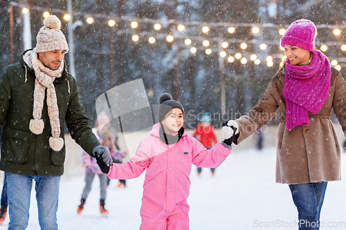 Image of happy family at outdoor skating rink in winter