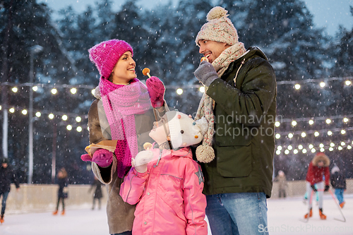 Image of happy family eating pancakes on skating rink