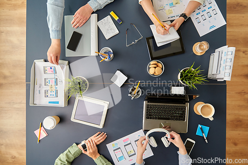 Image of business team with gadgets working at office table