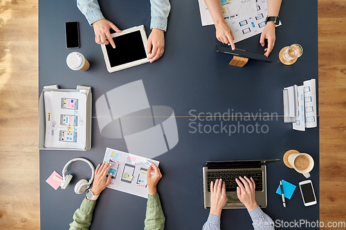 Image of business team with gadgets working at office table