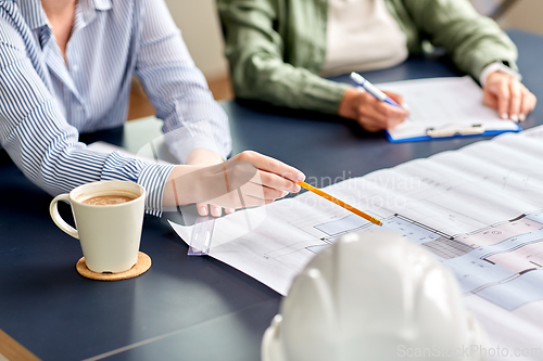 Image of business team with blueprint working at office