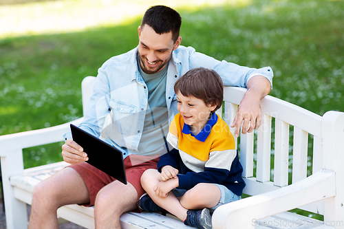 Image of father and son with tablet pc computer at park