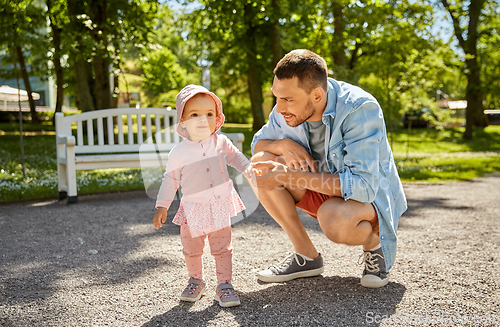 Image of happy father with baby daughter at summer park