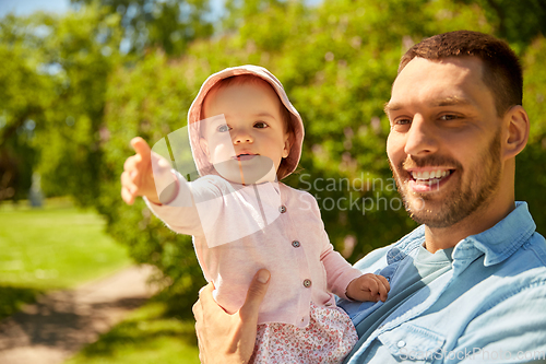 Image of happy father with baby daughter at summer park