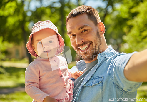 Image of happy father taking selfie with baby daughter