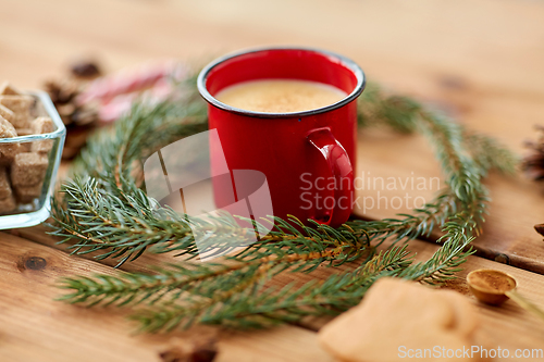 Image of cup of eggnog, fir branches, gingerbread and sugar