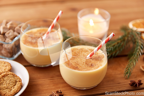 Image of glasses of eggnog, oatmeal cookies and fir branch