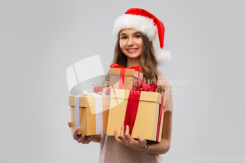 Image of teenage girl in santa hat with christmas gift